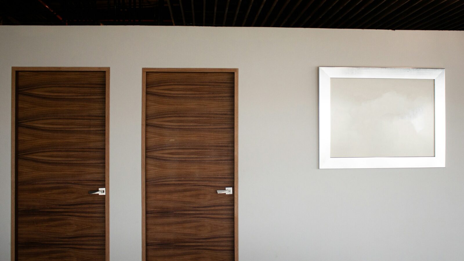 Wood interior door beside a white wall